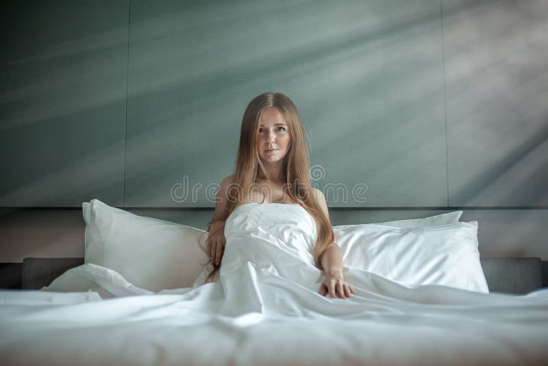 Woman With Beautiful Long Hair Sitting And Relax On The Bed With White