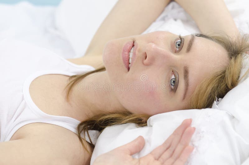 Woman in bed daydreaming