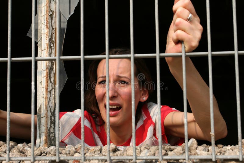 Woman behind bars crying