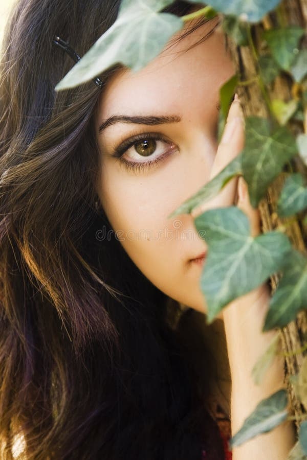 Woman behind leaves