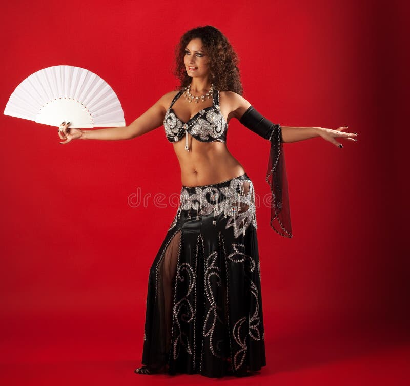 Woman belly dance with fan. 