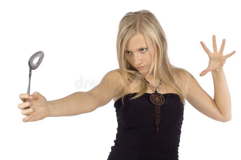 Woman bending spoon by mind force stock image Woman bending spoon by mind force stock image