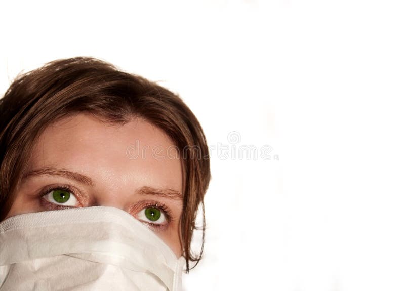 Woman with big green eyes wearing medical mask