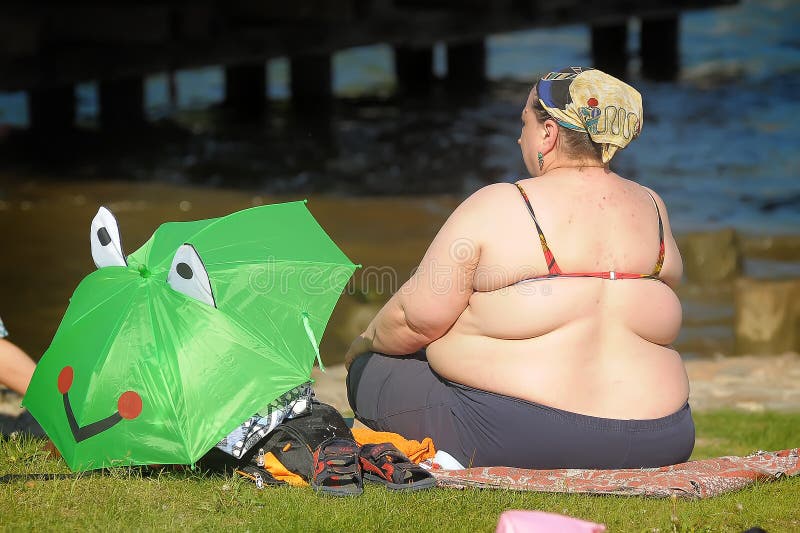 Woman big physique on a public beach