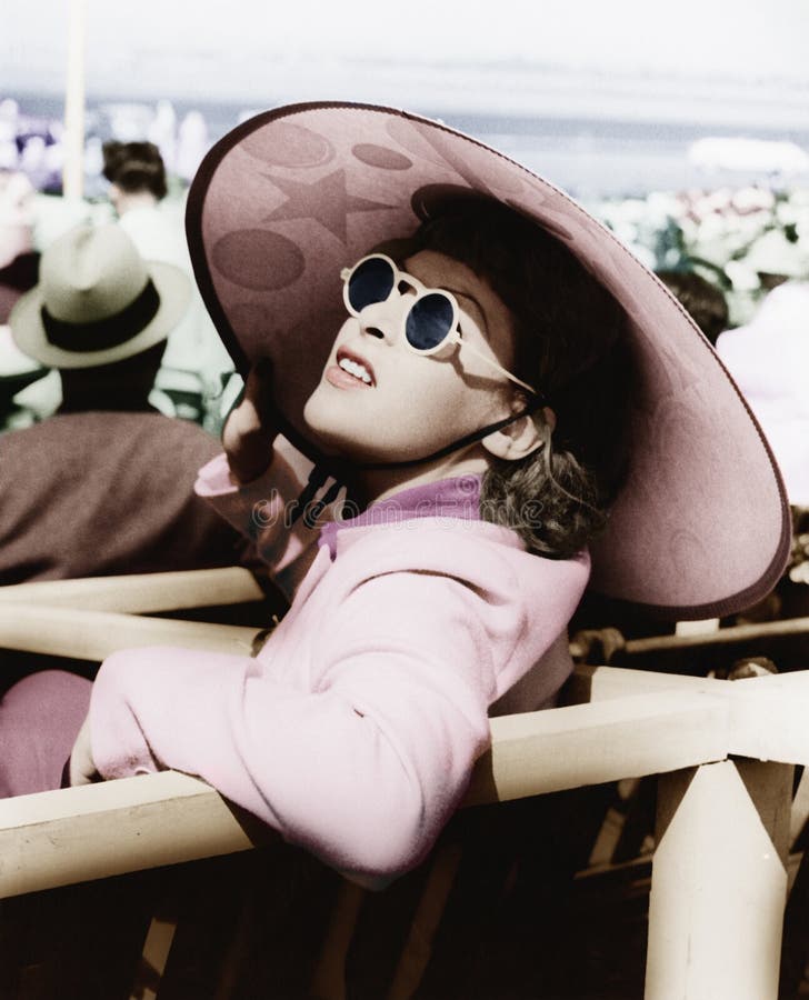 Woman in a big sun hat and sun glasses