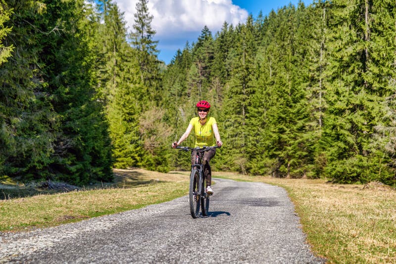 Woman on bike in forest