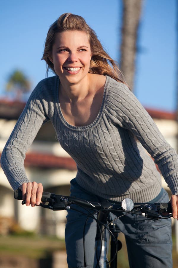Woman riding bike stock image. Image of outdoors, riding 54960413
