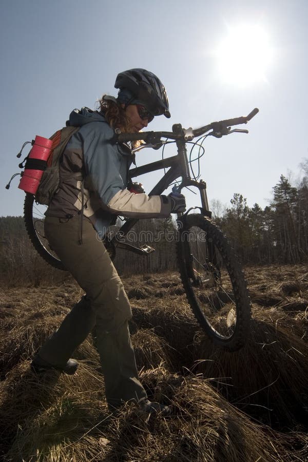 Woman biker in swampland