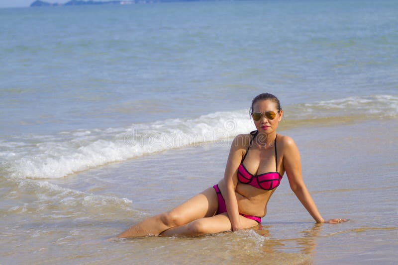 Woman and Bikini Pink Show on Beach Stock Image