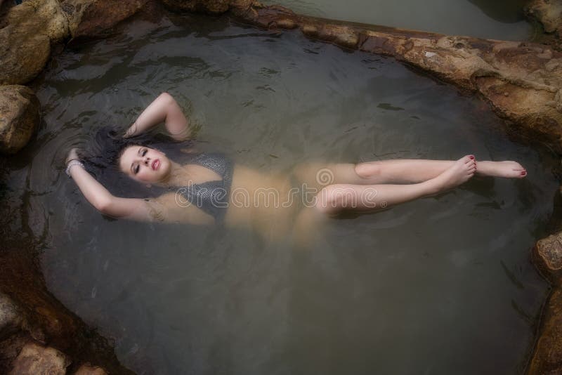 Woman in bikini relaxed in water.