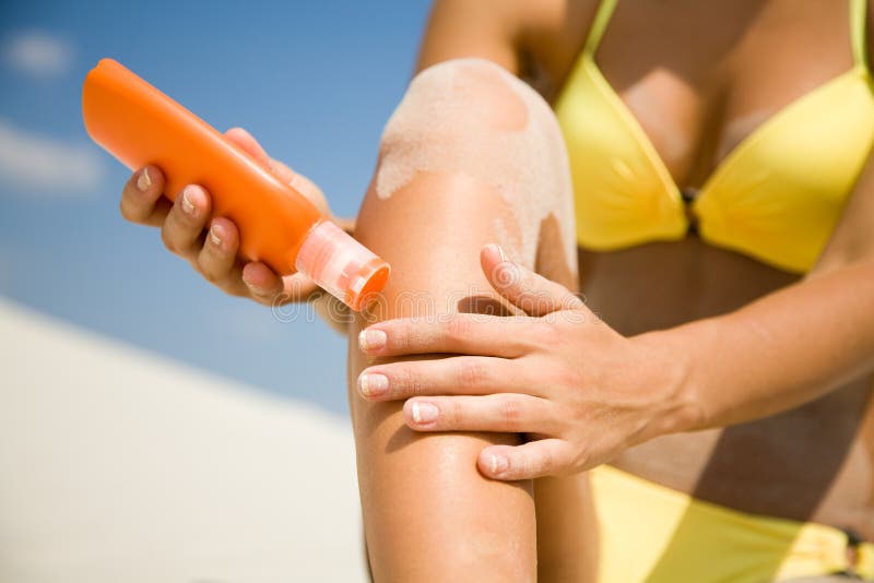 Woman in bikini smear protective cream stock photo Woman in bikini smear protective cream stock photo