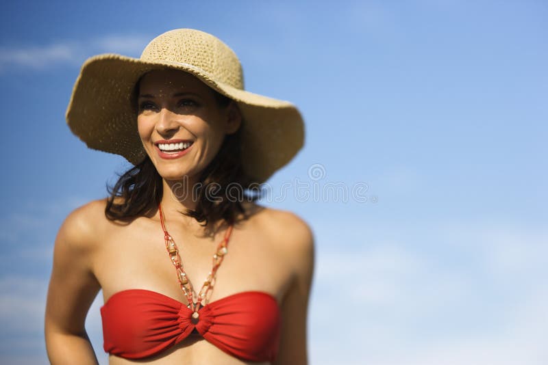 Woman in bikini and straw hat.