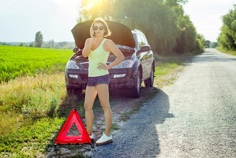 Woman With A Black Car That Broke Down On The Road Making Telephone 