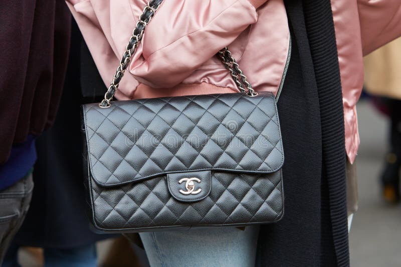 Woman with black leather Chanel bag before Salvatore Ferragamo fashion  show, Milan Fashion Week street style on September 25 Stock Photo - Alamy