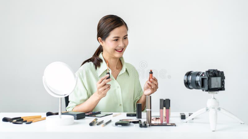 Woman blogger is present make up tutorial beauty cosmetic review product and broadcast live streaming video to teaching online on stock photo
