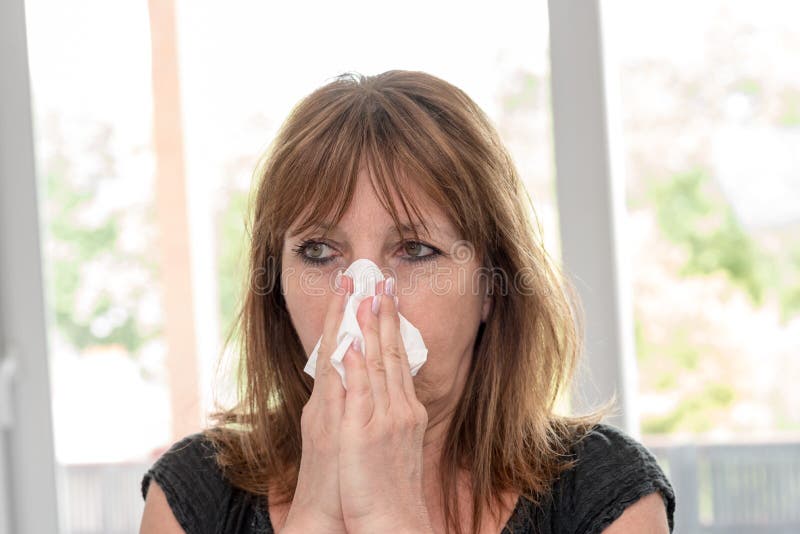 Woman blowing her nose stock images Woman blowing her nose stock images