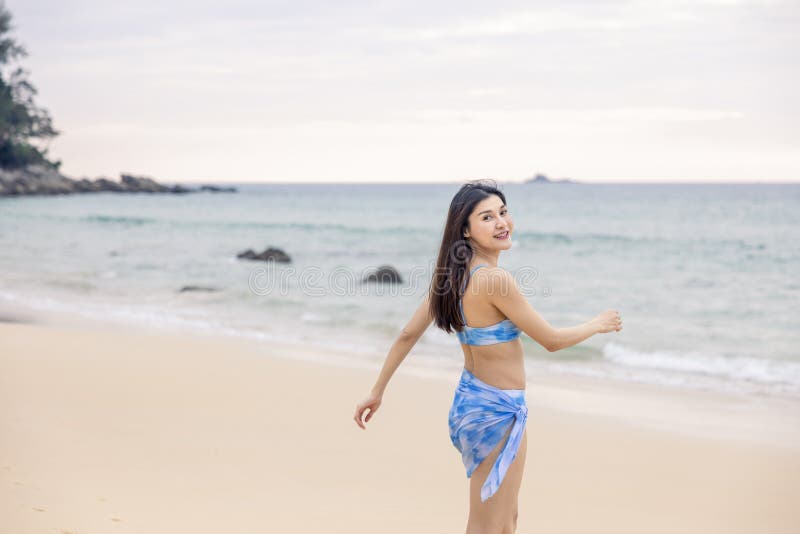 Woman with this Blue Bikini is Taking a Stroll on the Beach at Nai Thon Beach, Phuket, Thailand, the Backdrop is Stock Image - Image of people, happy: 213324659
