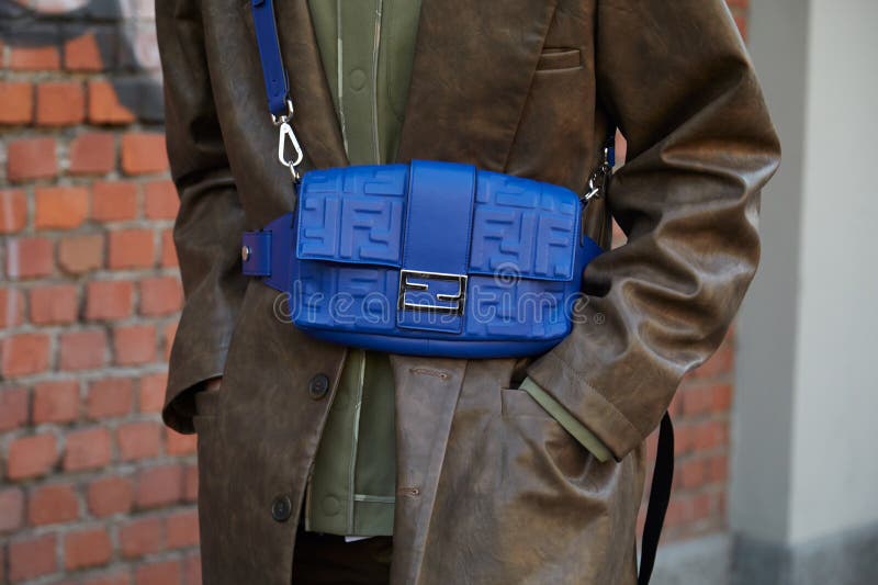 Woman with blue Fendi bag and brown leather coat before Fendi fashion show, Milan Fashion Week