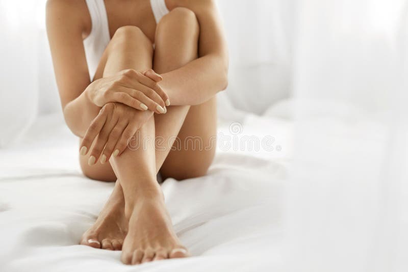 Woman Body Care. Close Up Of Long Legs With Soft Skin And Hands