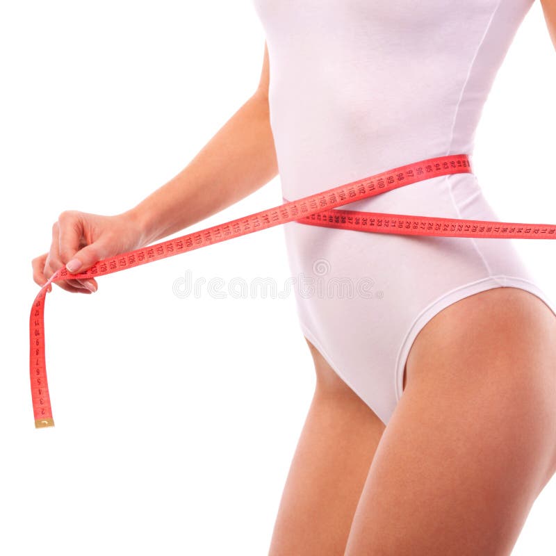 Woman body with measure tape. Close up of sporty and beautiful female body. Tanned woman measuring waist and hips with measuring