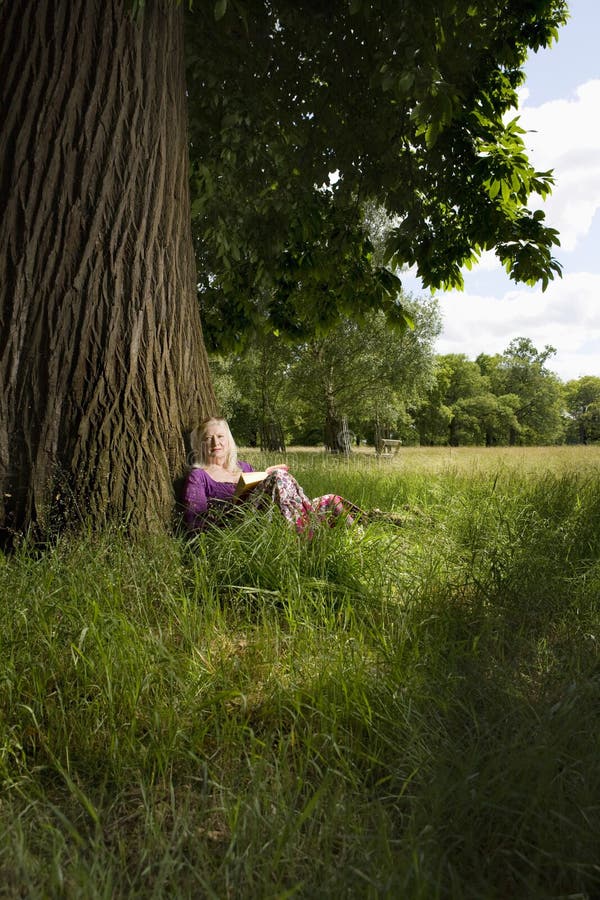 Woman Book Sitting Beneath Tree Stock Photos Free & RoyaltyFree