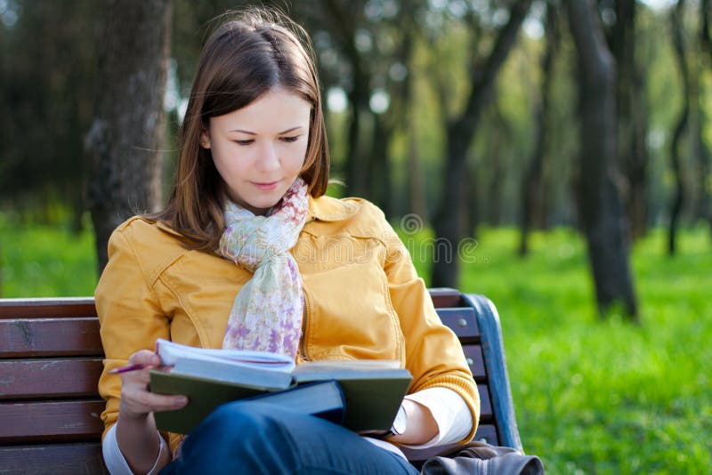 Woman with book in park