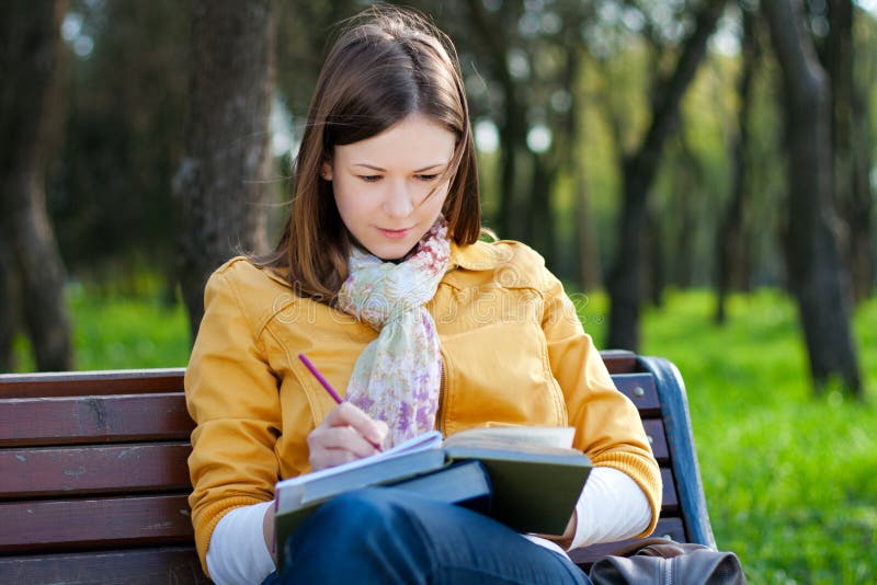 Woman with book in park