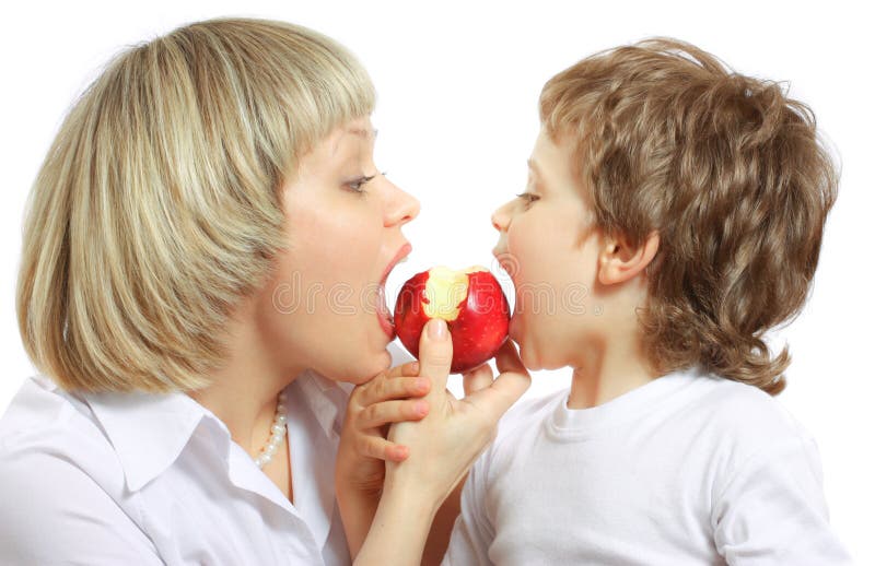 Woman and boy eating apple