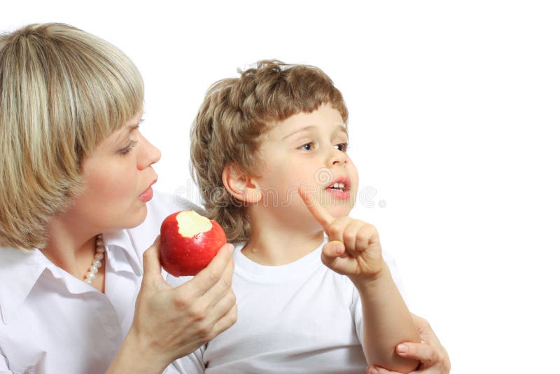 Woman and boy eating apple