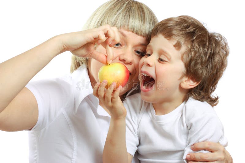 Woman and boy eating apple