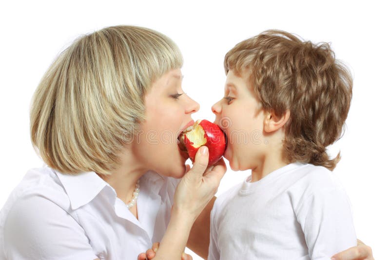 Woman and boy eating apple