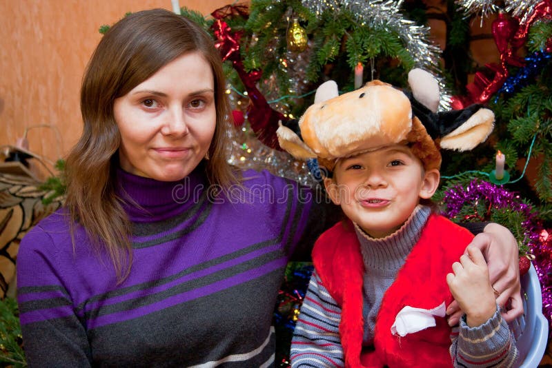 Woman and boy in the suit of calf near a new-year tree. Kid calf stock images, royalty-free photos and pictures