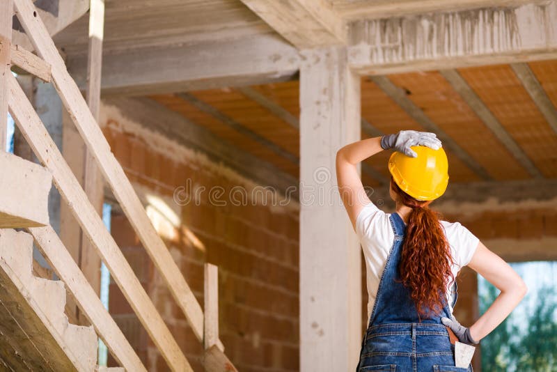 Woman Bricklayer Watching Upstairs royalty free stock image