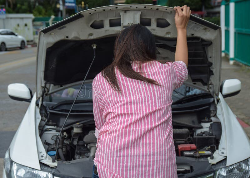 Woman and broken down car on road checking problem in engine. Accident and breakdowns with auto concept stock images Woman and broken down car on road checking problem in engine. Accident and breakdowns with auto concept stock images