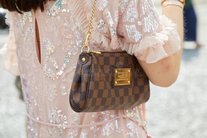 Woman with brown Louis Vuitton checkered bag on September 22, 2018