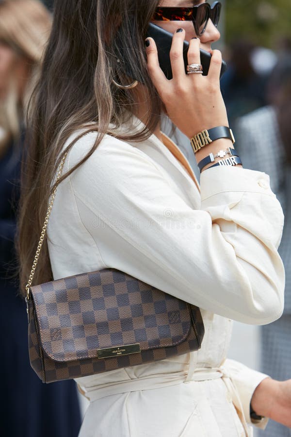 Woman with brown Louis Vuitton checkered bag on September 22, 2018