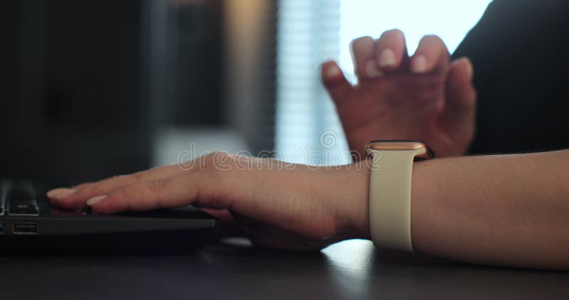Woman browsing notifications on modern smart watches while working. Young woman using smart watch. stock video footage