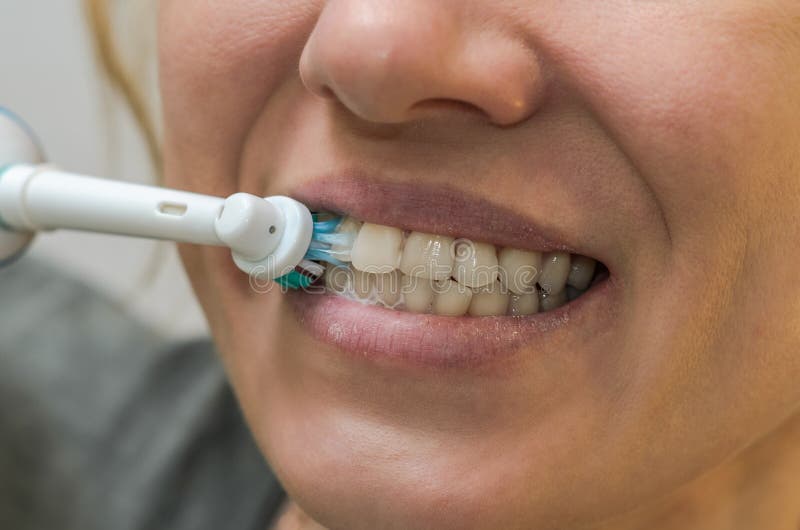 Woman Brushes Her Teeth with an Electric Toothbrush Stock Image Image
