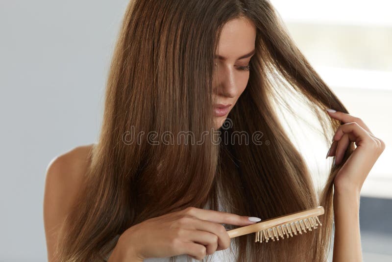 Hair Care. Closeup Of Beautiful Woman Hairbrushing. Portrait Of Female Model Brushing Shiny Long Straight Healthy Hair With Hairbrush. Health And Beauty Concept. High Resolution Image. Hair Care. Closeup Of Beautiful Woman Hairbrushing. Portrait Of Female Model Brushing Shiny Long Straight Healthy Hair With Hairbrush. Health And Beauty Concept. High Resolution Image