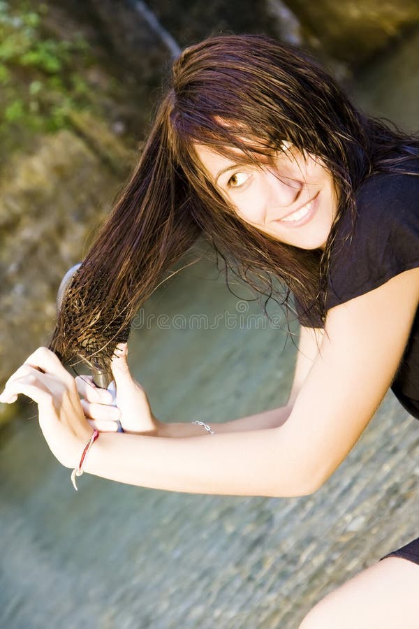 Brushing her hair stock photo. Image of serious, styling 6612630