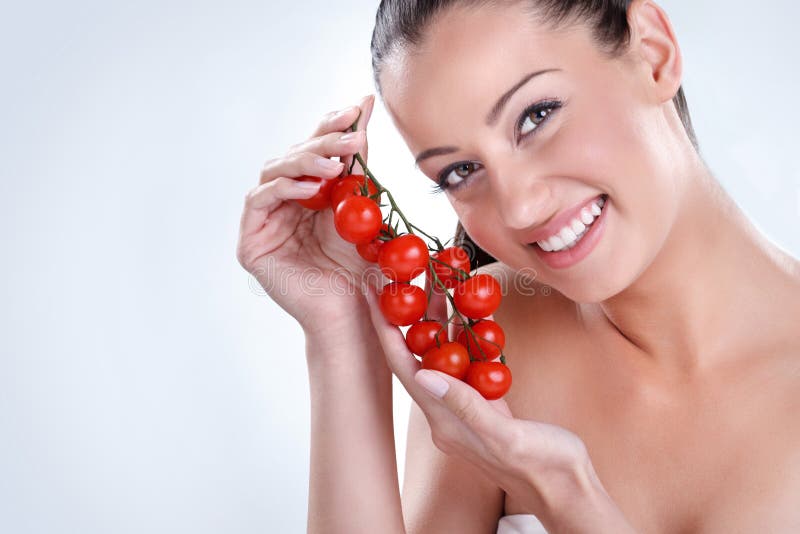 Woman with bunch of Cherry tomatoes.