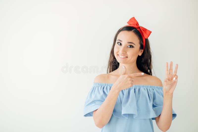 Woman business executive showing 3 or three fingers hand gesture