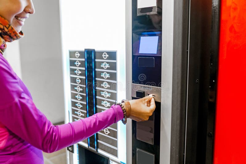 Woman buying coffee at selling machine stock photo Woman buying coffee at selling machine stock photo