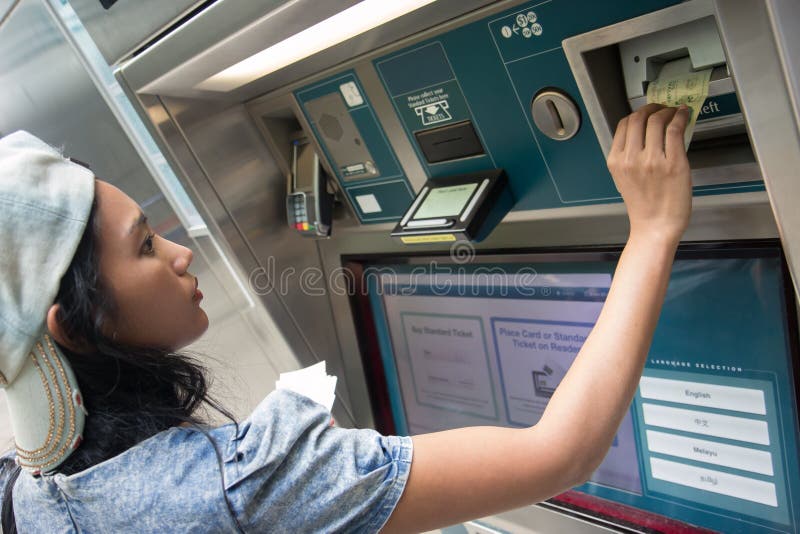 Woman buys a ticket vending machine stock photo