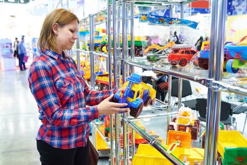 Woman buys toy car in children store royalty free stock photography Woman buys toy car in children store royalty free stock photography