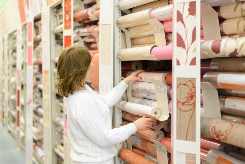 Woman buys wallpaper in store
