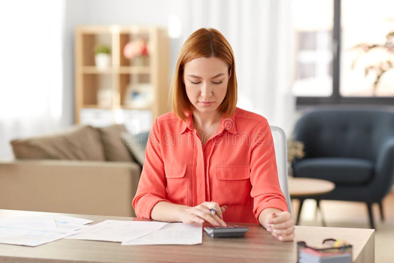 Woman with calculator and papers working at home royalty free stock photos Woman with calculator and papers working at home royalty free stock photos