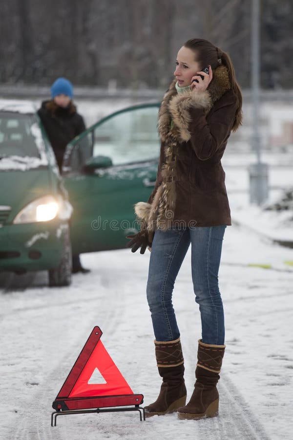 Woman calling car service by breakdown