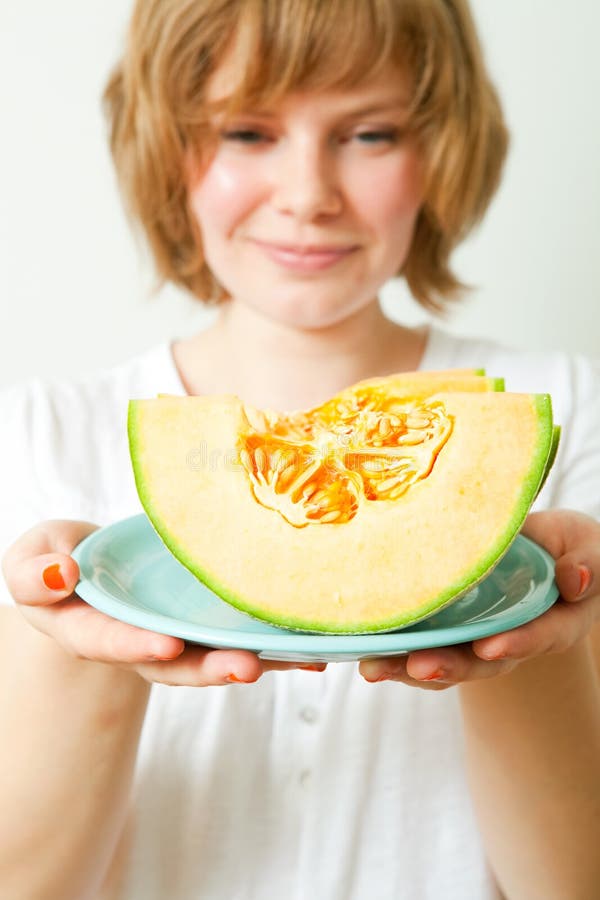 Woman with cantaloupe melon