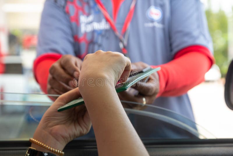Woman in car paying gasoline with credit card, female holding debit card payment at gas station. Petrol oil loyalty mileage point. royalty free stock photo Woman in car paying gasoline with credit card, female holding debit card payment at gas station. Petrol oil loyalty mileage point. royalty free stock photo